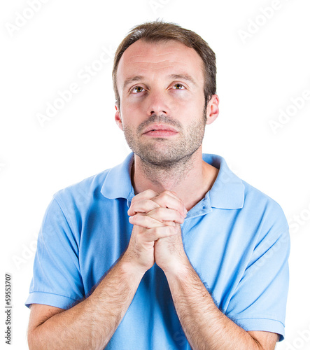  portrait young man with open eyes looking up praying  