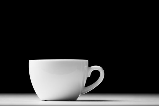 Defocused lights as aroma emanates from white coffee cup