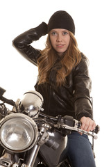 Fototapeta na wymiar woman black leather motorcycle hand on hat