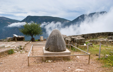 The Sacred Omphalos Stone against the dramatic landscape, Delphi, Greece