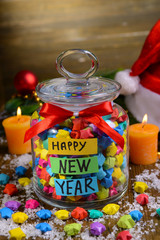 Paper stars with dreams in jar on table on wooden background