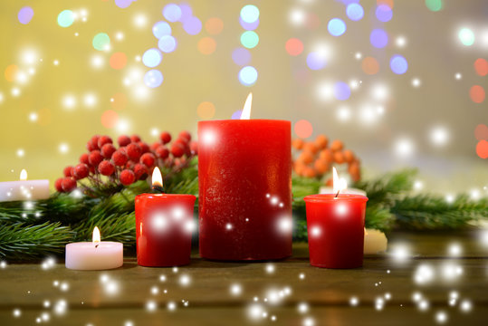 Candles and Christmas decoration on bright background