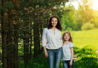Fototapeta premium Portrait of happy mother and daughter outdoor