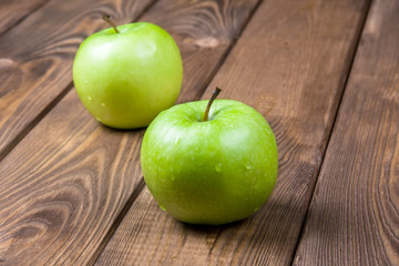Two apples on a wooden background close up