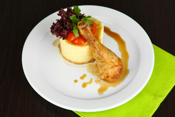 Small portion of food on big plate on wooden table