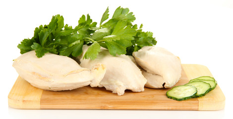 Boiled chicken breast on wooden cutting board isolated on white