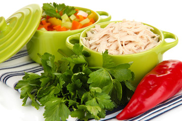 Shredded boiled chicken in green pan close up