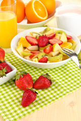 Useful fruit salad of fresh fruits and berries in bowl