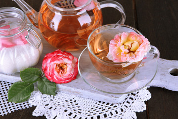 Kettle and cup of tea from tea rose