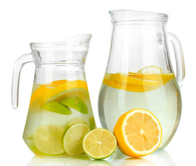 Cold water with lime, lemon and ice in pitchers isolated