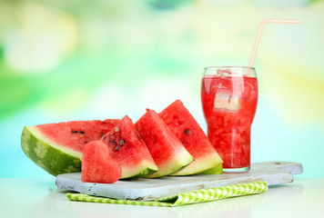 Fresh watermelon and glass of watermelon juice, outdoors