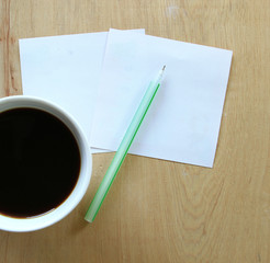 cup of fresh coffee on table, view from above