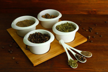 Assortment of spices in  white spoons and bowls,
