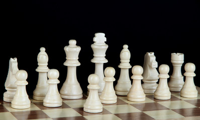 Chess board with chess pieces isolated on black