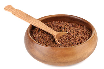 Buckwheat groats in bowl and wooden spoon isolated on white
