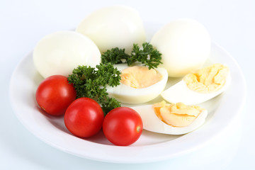Obraz na płótnie Canvas Boiled eggs on plate isolated on white