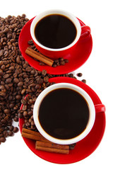 Red cups of strong coffee and coffee beans close up