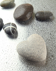 Grey stone in shape of heart, on light background