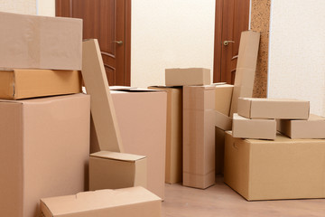 Empty room with stack of cartons: moving house concept