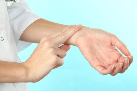 Measuring  pulse on light blue background