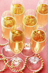 Glasses with champagne on shiny background