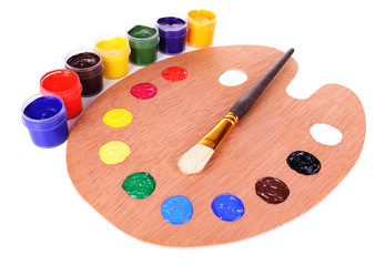 Wooden art palette with paint and brush isolated on white