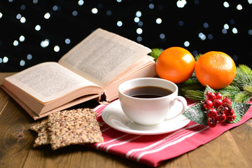 Composition of book with cup of coffee and Christmas