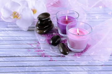 Beautiful colorful candles and  orchid flowers,