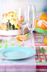 Table serving with colorful tableware on room background