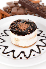 Sweet cake with chocolate on plate close-up