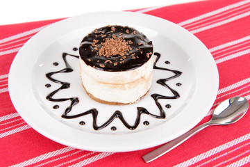 Sweet cake with chocolate on plate on table close-up
