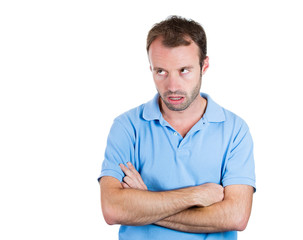 Grumpy, unhappy, jealous young man looking sideways