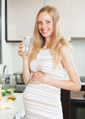 Happy pregnant woman with water