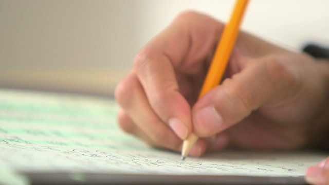 Close up of business woman writing with pencil