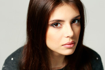 Fototapeta premium Closeup portrait of a young pensive woman