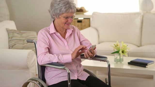 Old woman happily using smartphone
