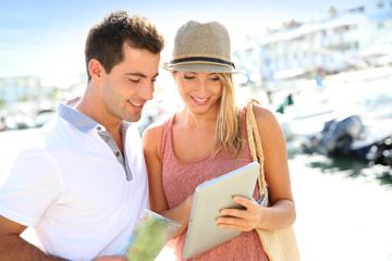 Couple looking at tourist information on tablet