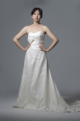 beautiful smiling girl in a white wedding dress posing