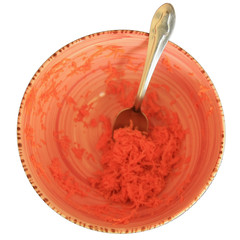 Grated carrots in a bowl isolated on white background