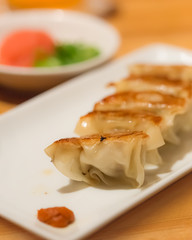 Homemade Asian pork gyoza on a white plate