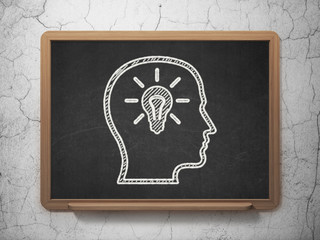 Education concept: Head With Lightbulb on chalkboard background