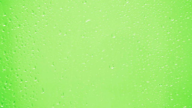 drops on glass - green background