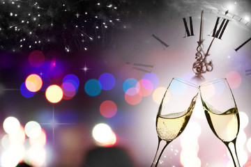 Glasses with champagne against fireworks and clock