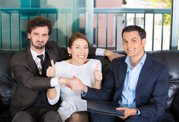 Happy couple in office of finical adviser ready to sign contract
