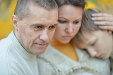 Fototapeta premium Sad family of three on the nature
