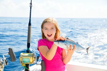 Fotobehang Blond kid girl fishing tuna bonito sarda fish happy catch © lunamarina