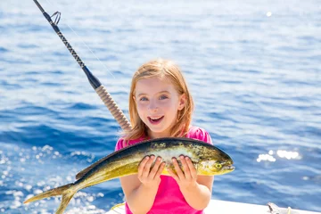 Foto auf Acrylglas Antireflex Blond kid girl fishing Dorado Mahi-mahi fish happy catch © lunamarina