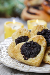 Poppy seed cookies in heart shape on the table, selective focus