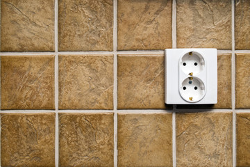 Double electric power socket on kitchen wall