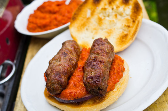 Cevapcici with ajvar in the grilled roll